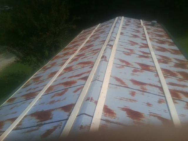 Rusted metal roof panels with new wood purlins before replacement — Storm Damage Roof Repair in Greer by Roofing Brothers