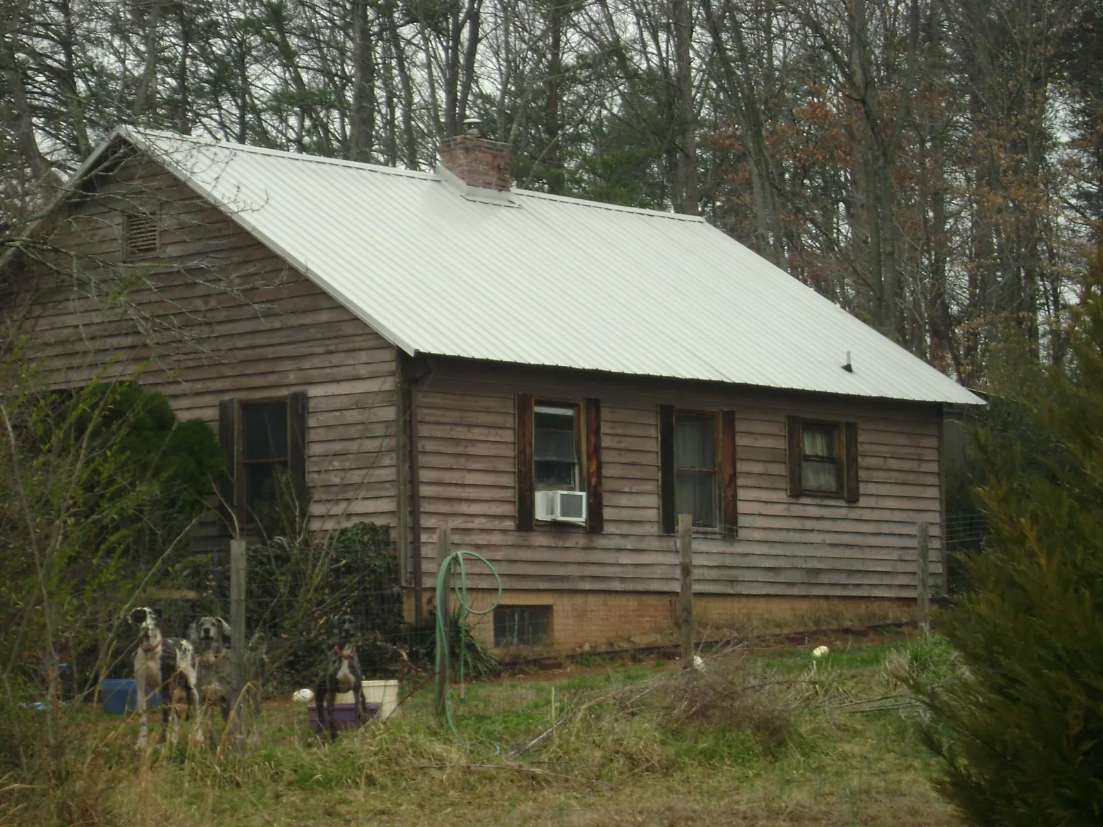 White metal roof on an old wood sided farmhouse, from a Metal Roof Installation job in Greer